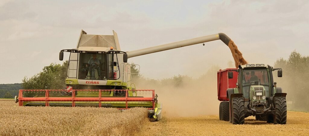 Monsoon Forecast and Its Impact on Agriculture Combine harvester unloading wheat at harvest